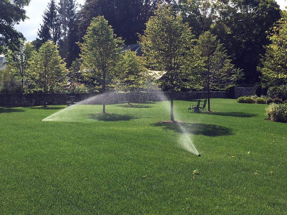 Sprinkler System Watering Lawn With Residential Irrigation System