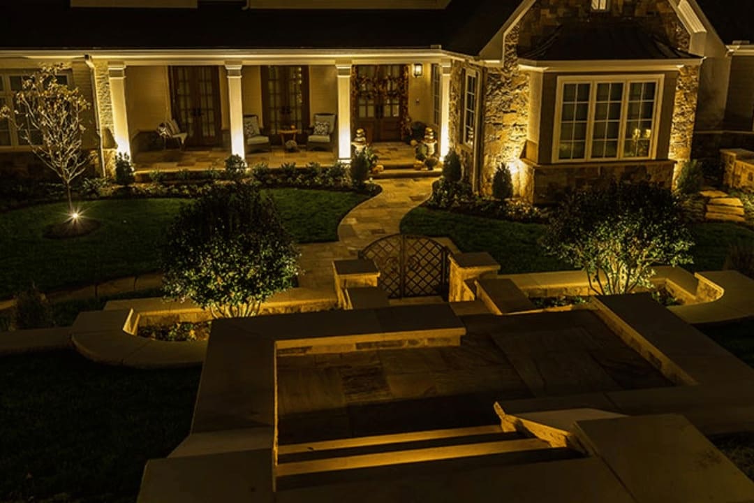 Well-lit residential walkway with landscape lighting improving safety and visibility at night